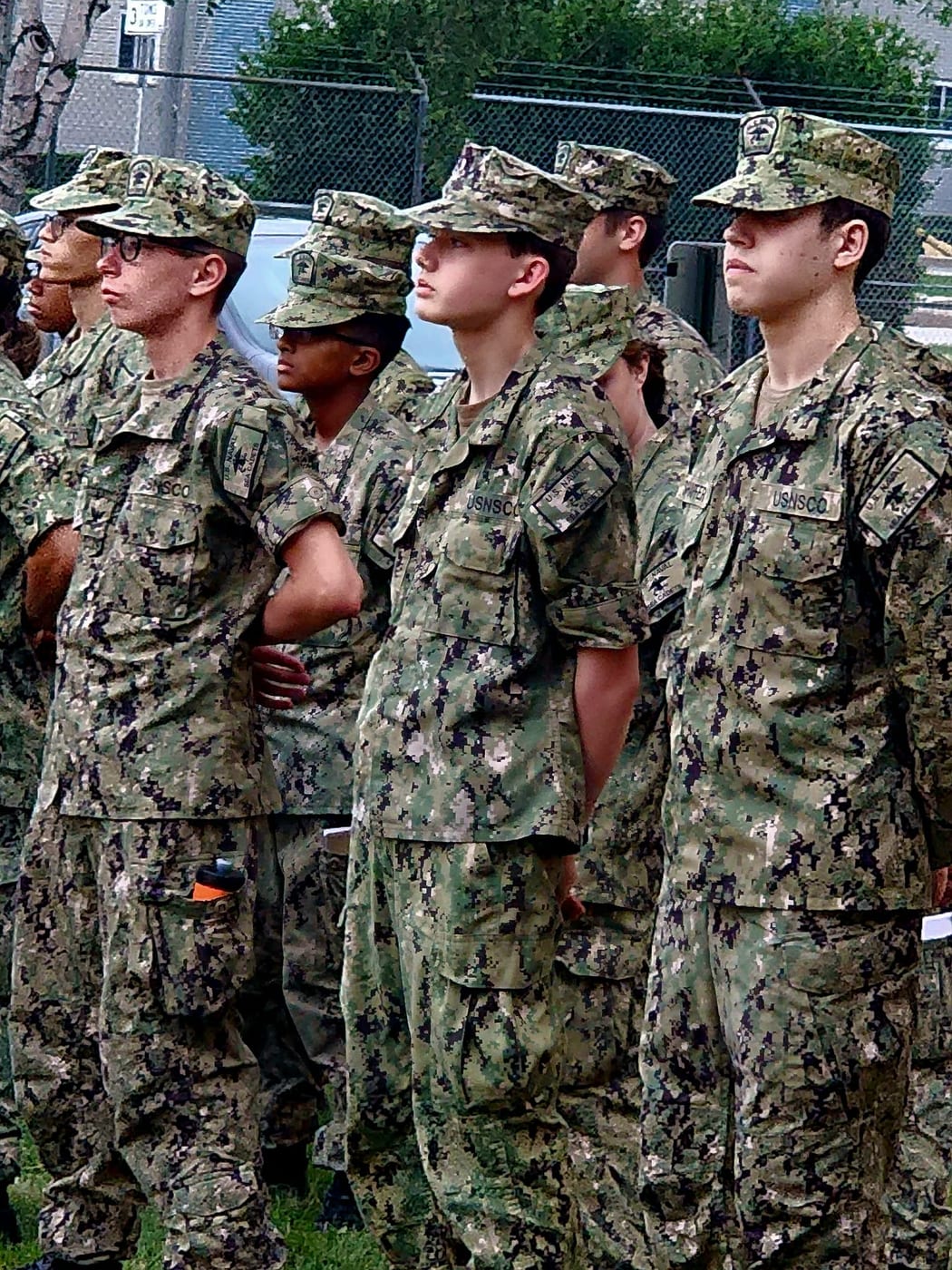 Cruiser Milwaukee cadets standing at attention in Navy Working Uniform during training