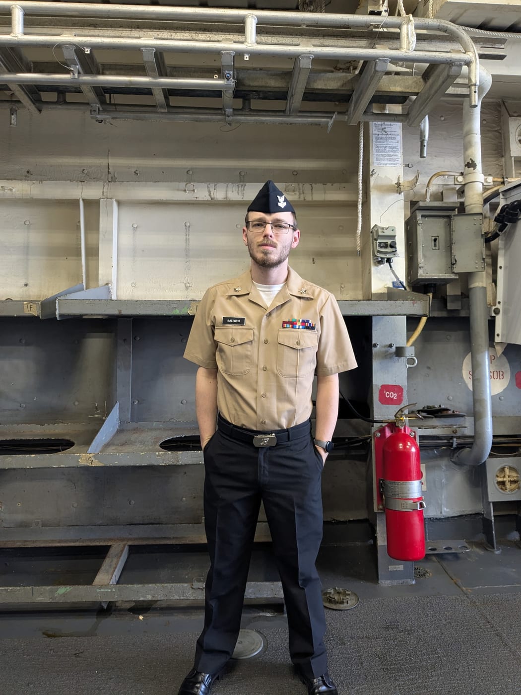 GSM2 Zachary Baltutis in Navy uniform aboard ship