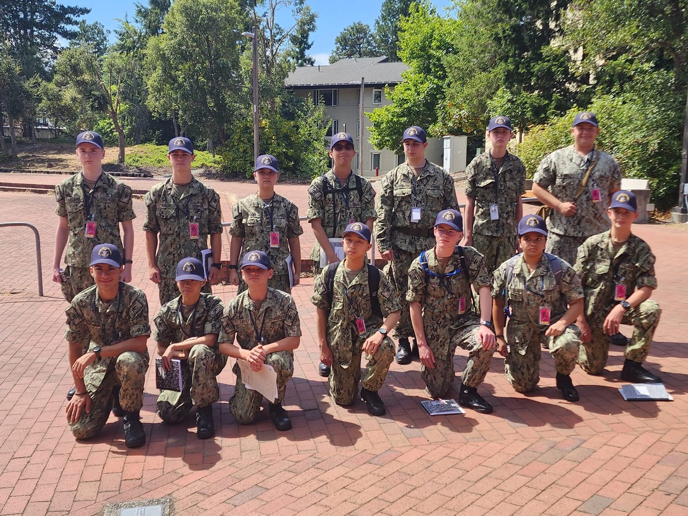 Group of Sea Cadets in Navy Working Uniform posing outdoors at an advanced training location