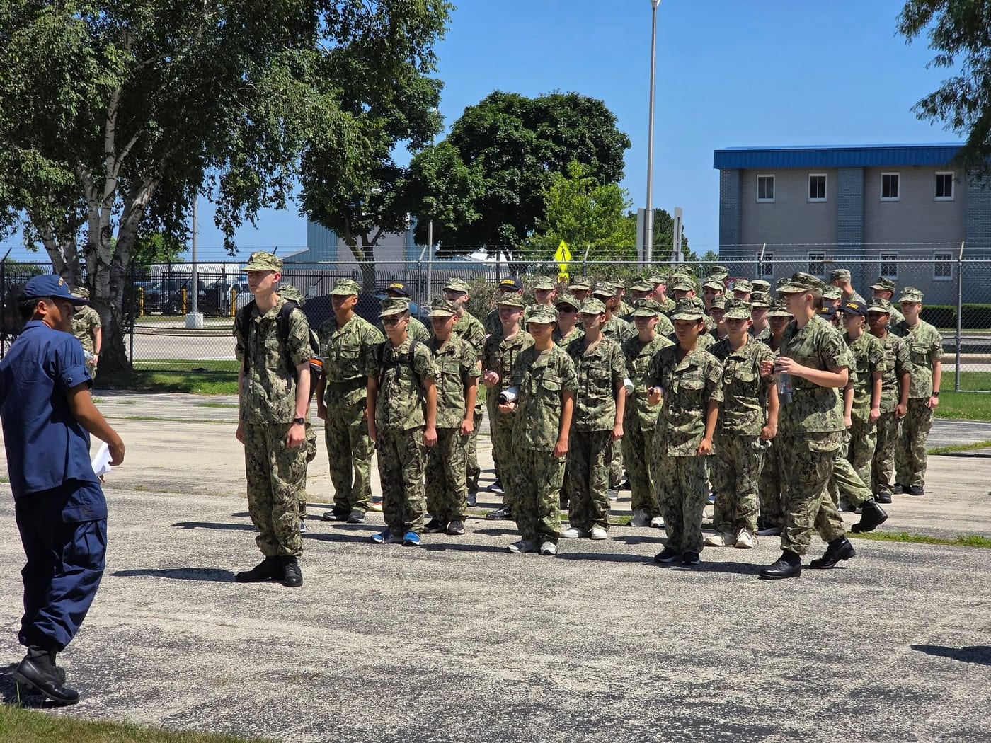 Large formation of Sea Cadets in Navy Working Uniform marching during training