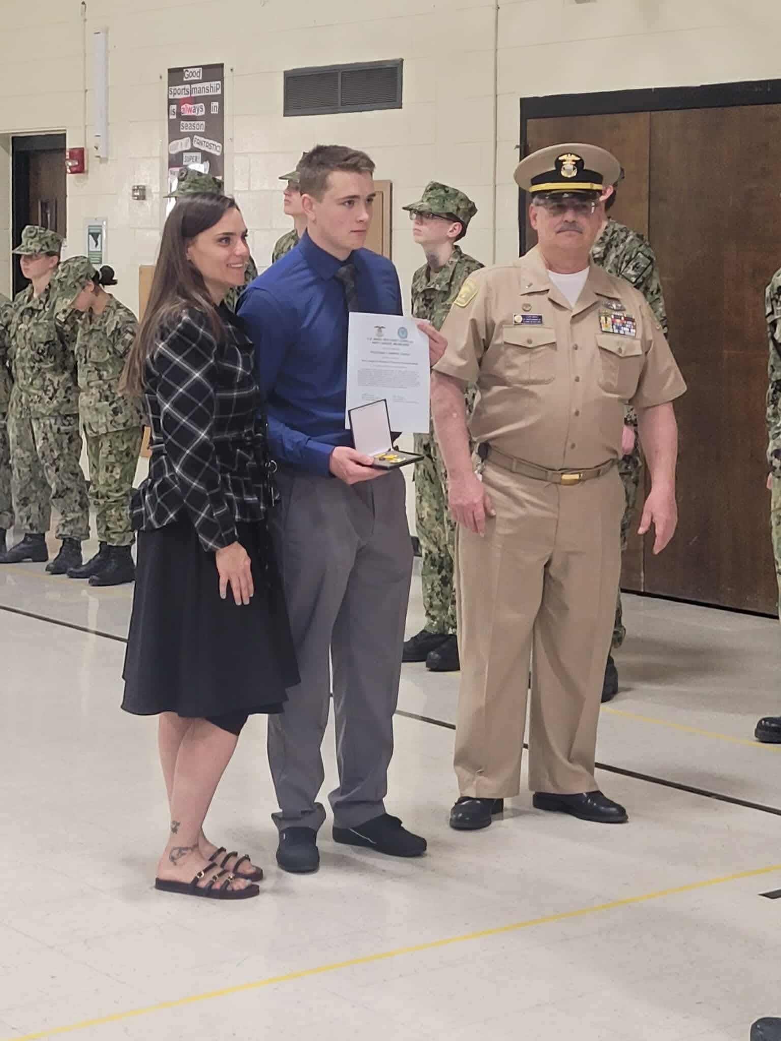 Ethan Harper receiving the NLUS Roosevelt Award medal at a ceremony