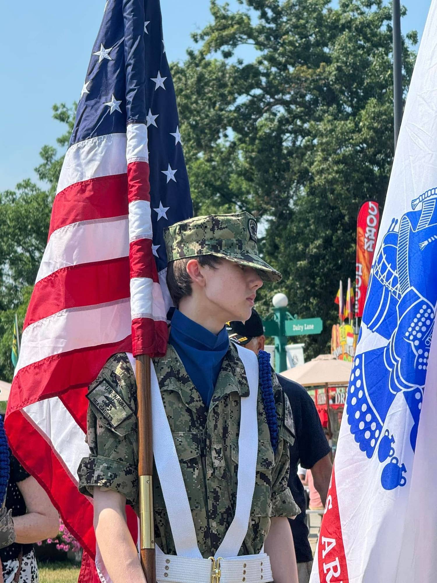 Jameson Lee carrying the national colors with the division Color Guard